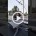 Video thumbnail: two utility workers in safety gear on a platform atop a truck, working on overhead power lines in a suburban street.